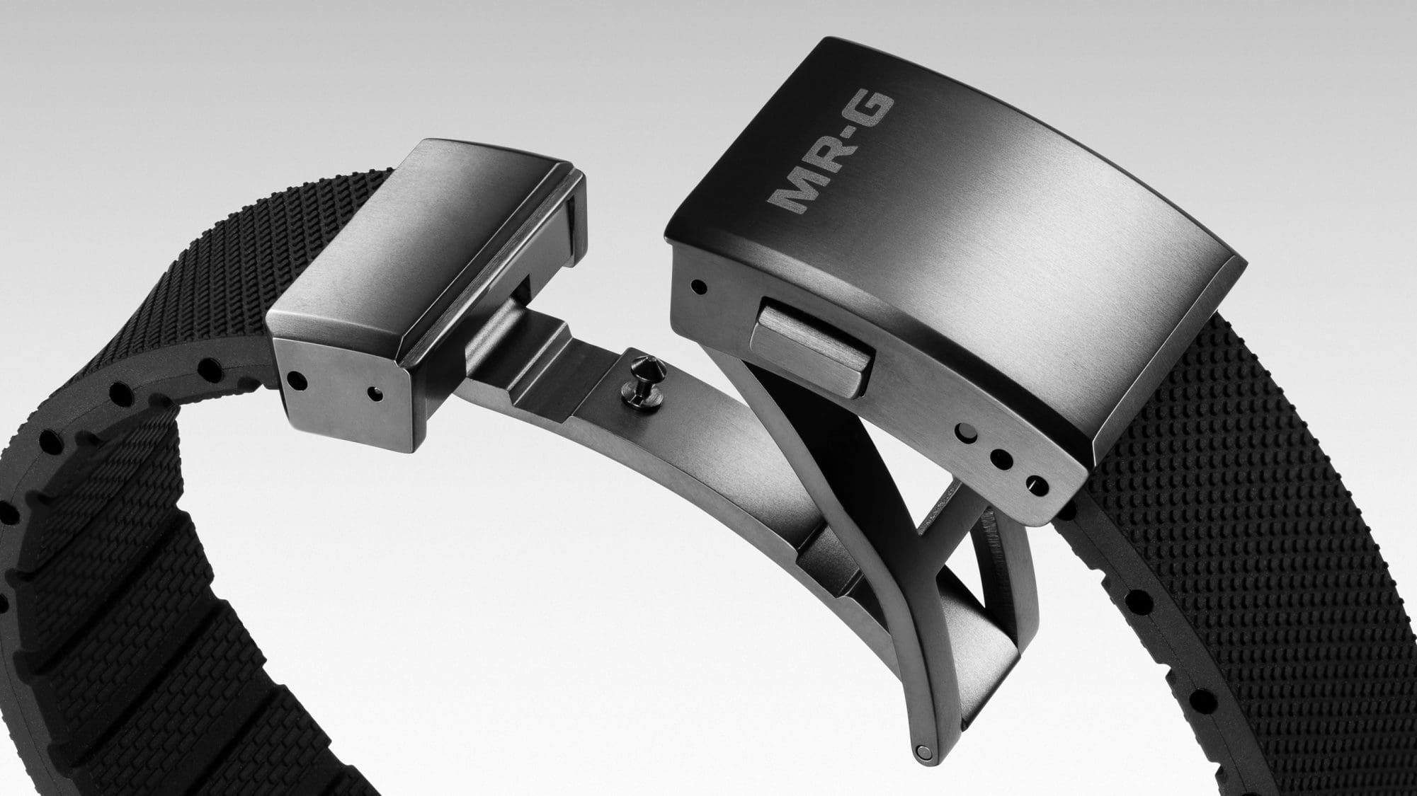 Close-up of the triple-folded, silver one-touch clasp and the black synthetic resin strap