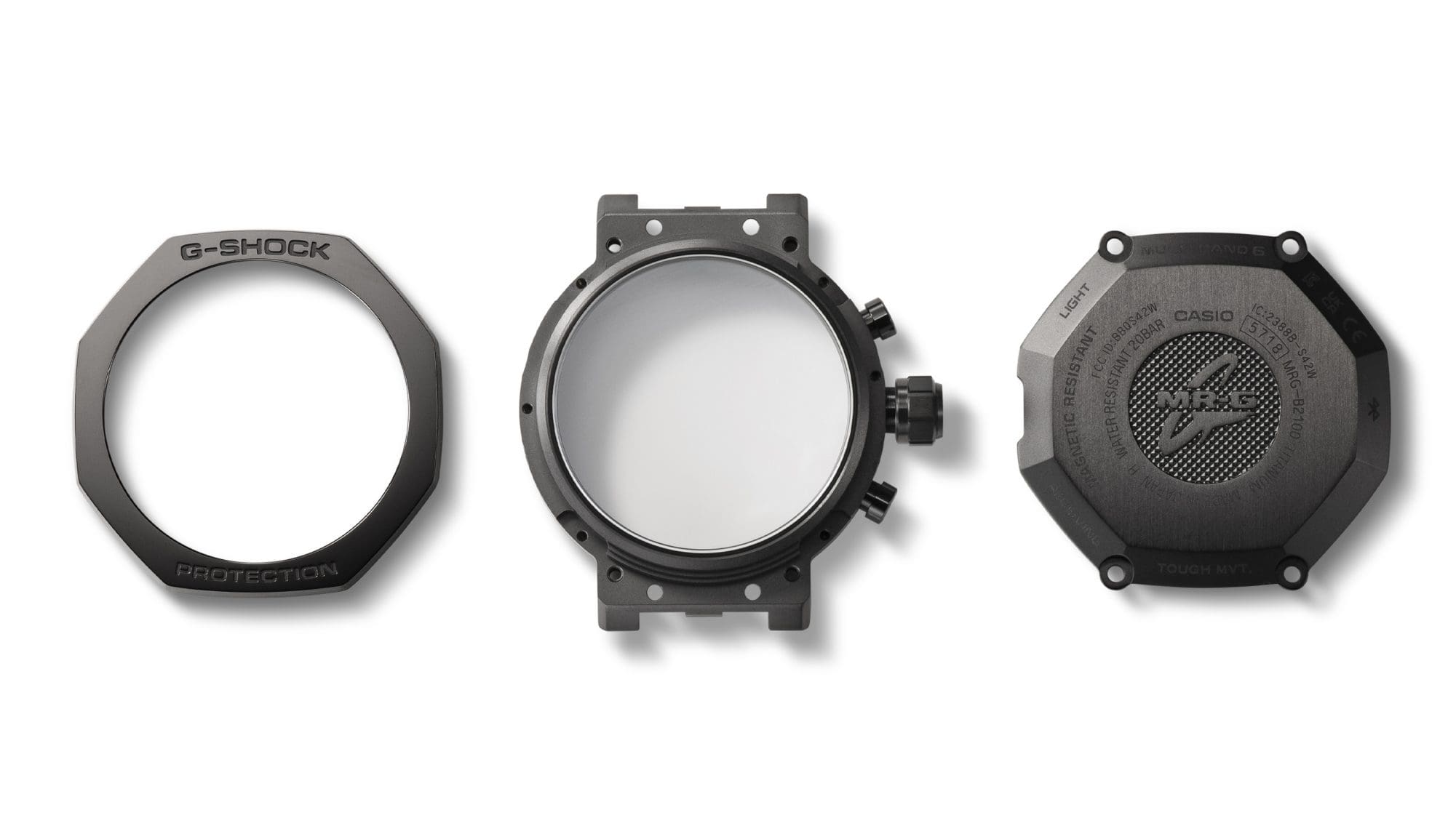 Bezel, case part with buttons and case back lying individually next to each other