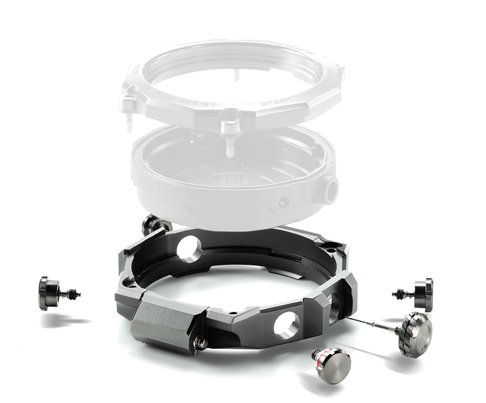 Individual components of the MTG-B2000 wristwatch case focussing on the metal frame and buttons