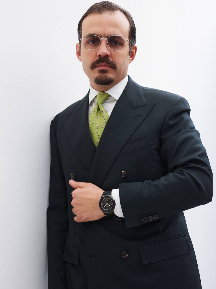 A male is wearing G-SHOCK GM-2100LXB-1A on his wrist.