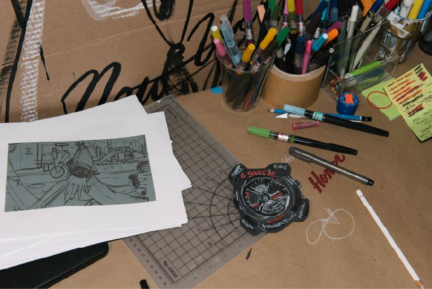 Art supplies and sketches arranged across Stephen Palladino's workspace.