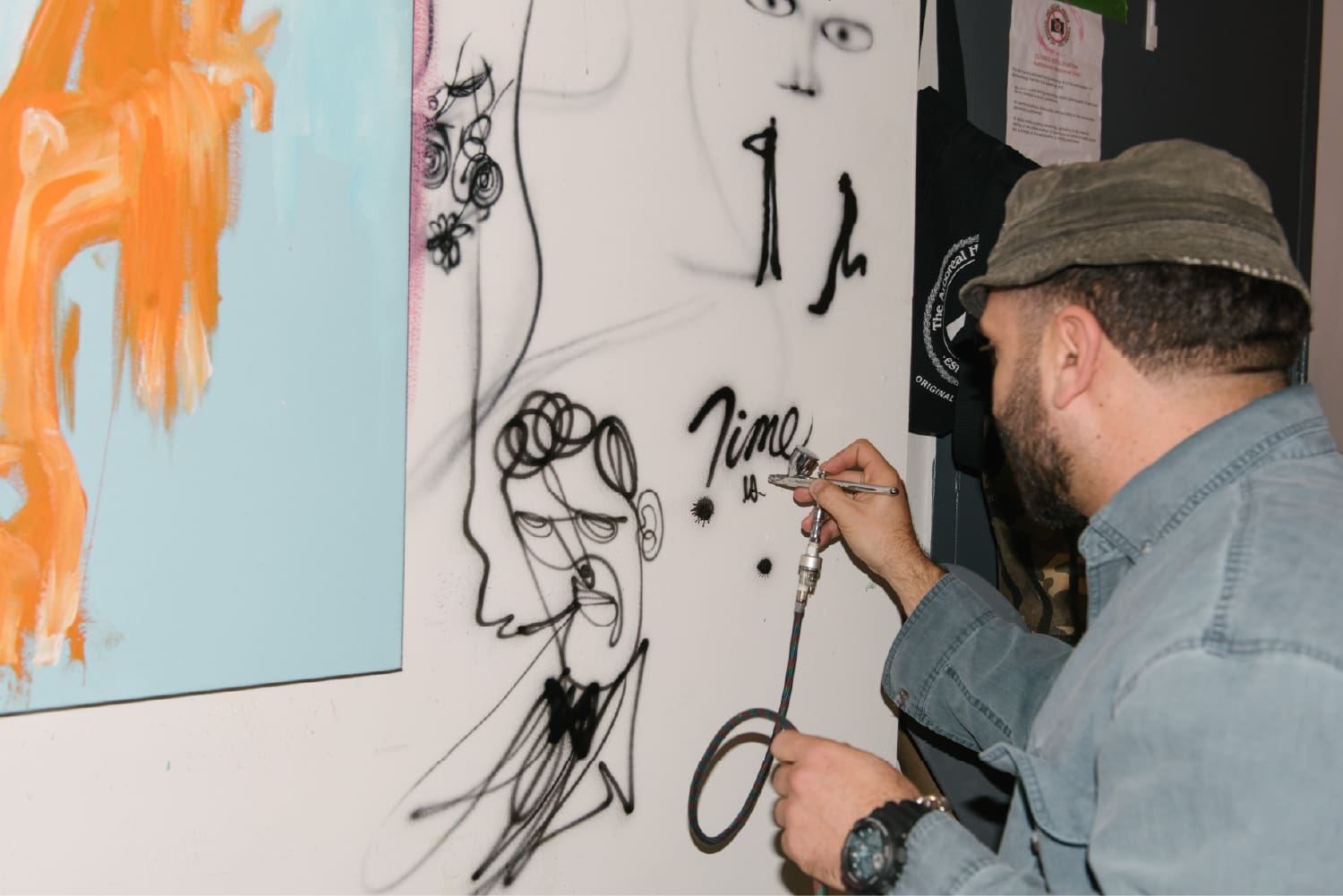 Stephen Palladino drawing original illustrations on a studio wall.