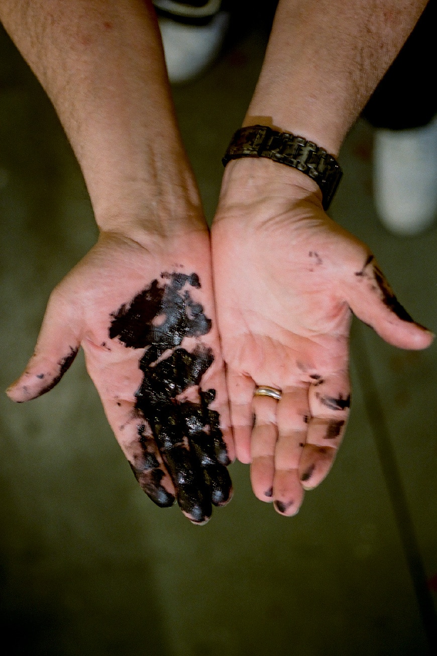 Eric Haze holding black graphic elements used in his artwork.