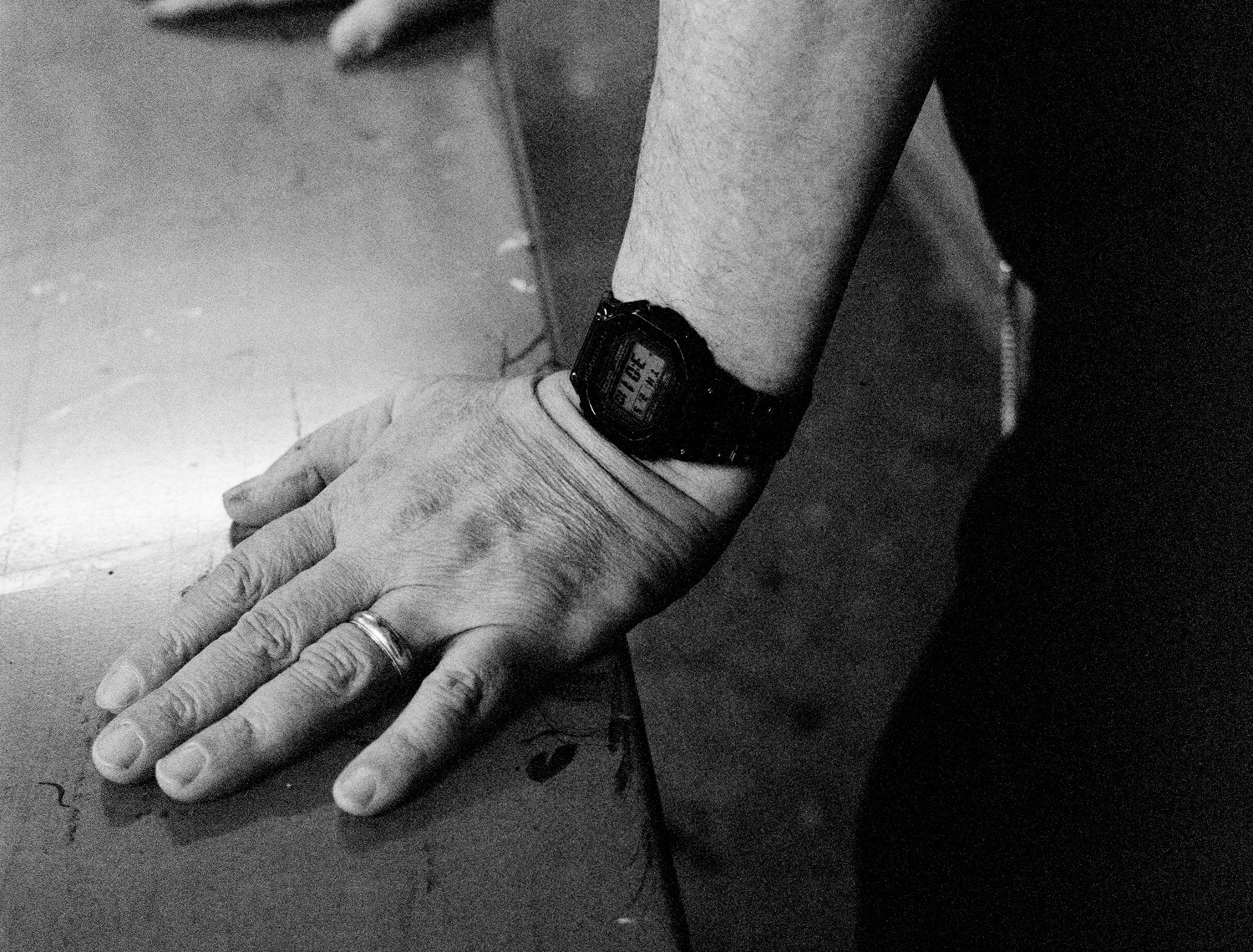 A close-up of a G-SHOCK watch worn on an artist's wrist while working.