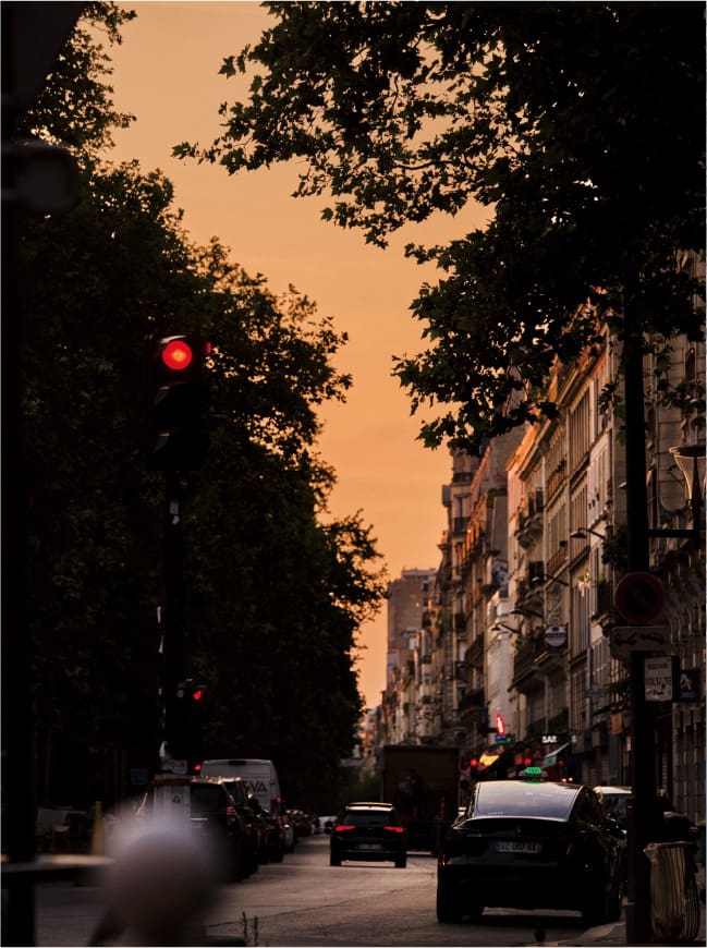  City street at sunset with cars.