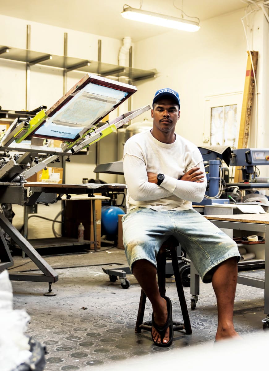 This is a photo of Pablo Attal sitting in his print workshop during an interview.