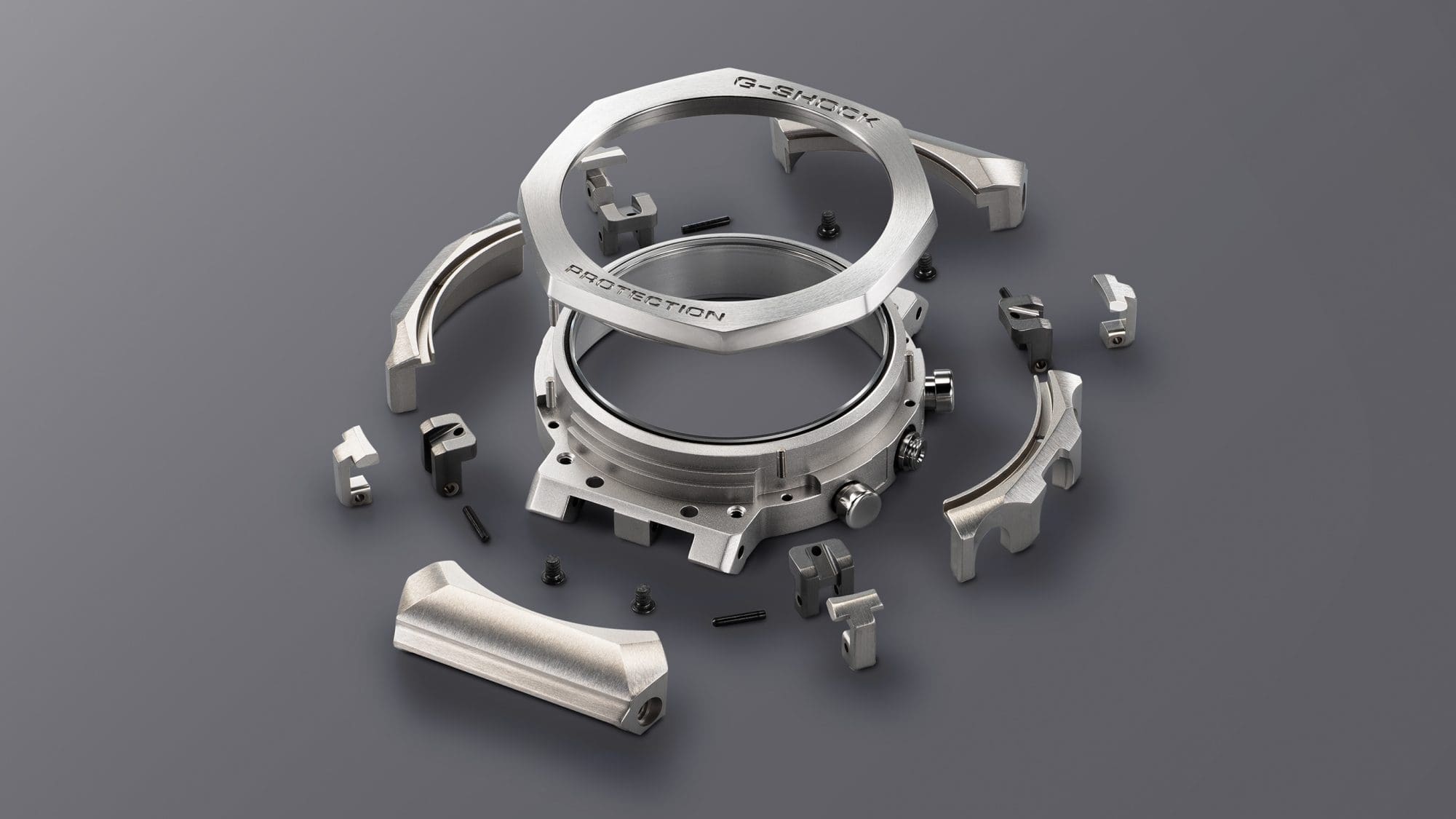 G-SHOCK MRGB2100D-1A titanium watch exploded view of the outer case, bezel, and case guards denoting style and toughness G-SHOCK MRGB2100D-1A titanium watch exploded view of the outer case, bezel, and case guards denoting style and toughness