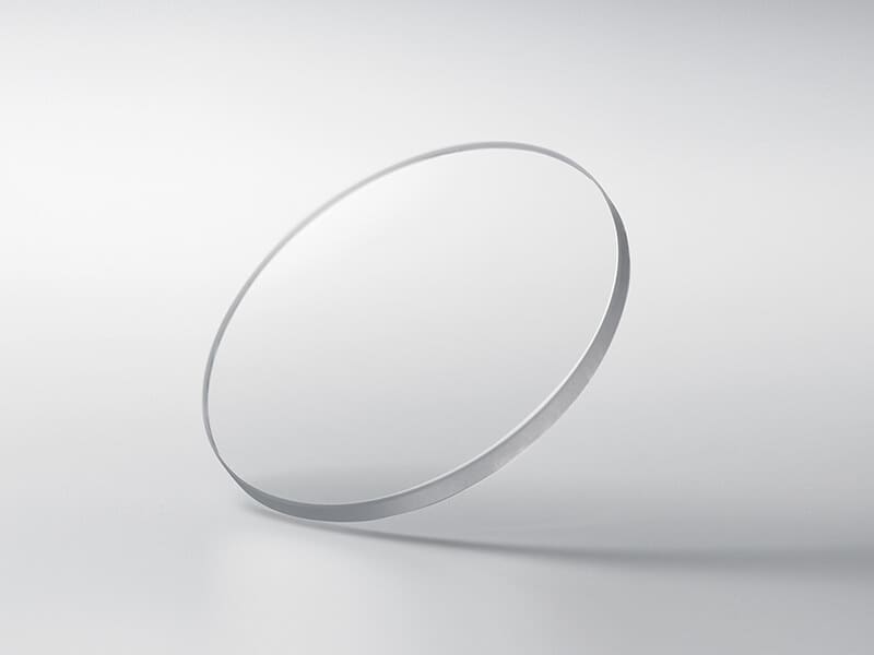 Disk of scratch resistant, transparent sapphire crystal