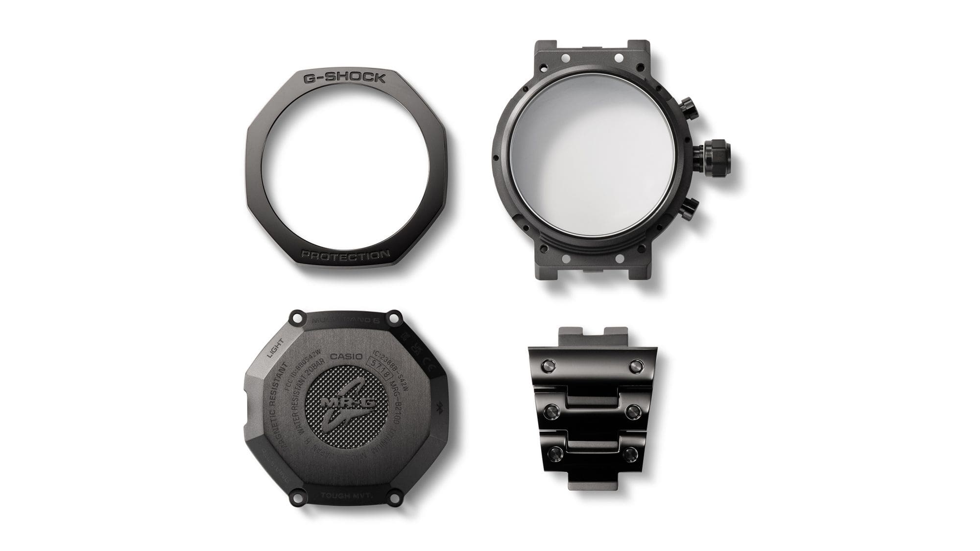 Cuatro componentes de la caja del reloj de pulsera MRG-B2100B uno al lado del otro.