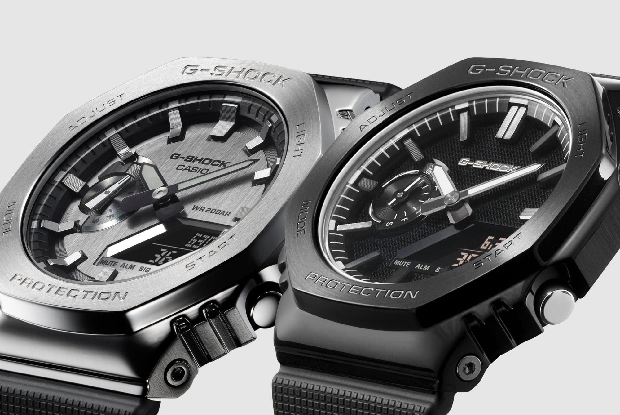 Gros plan des G-Shock GM-2100-1A et de la nouvelle GM-2100LXB-1A côte à côte afin de mettre en évidence leurs différences.