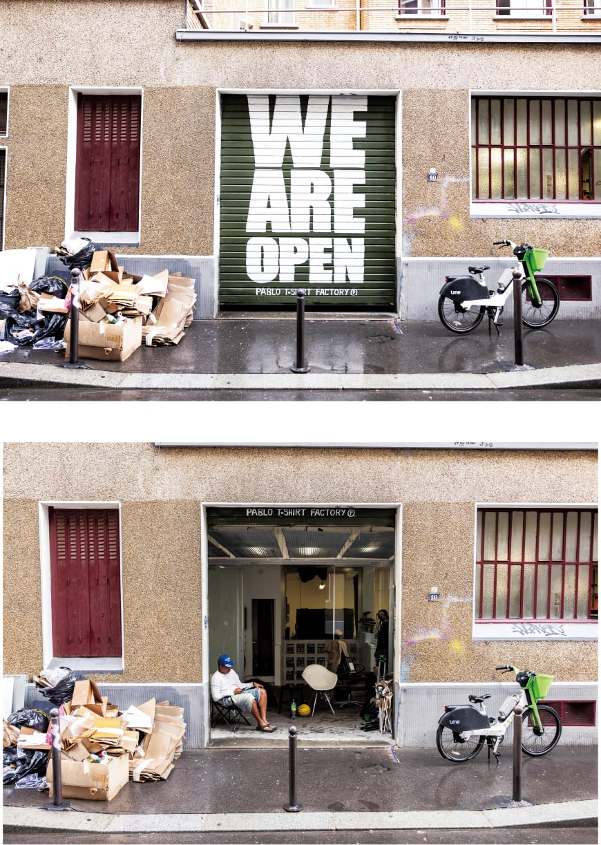 Il s'agit d'une photo de l'extérieur de l'atelier de Pablo Attal avec un panneau "Nous sommes ouverts".