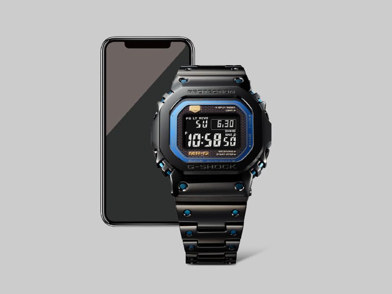 La montre G-Shock MRG-B5000BA-1 Bluetooth® devant un smartphone
