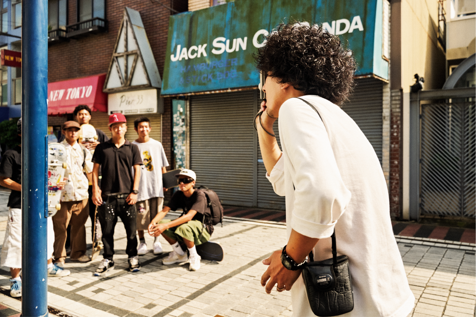 Uma imagem de Yamatani a fotografar os jovens skaters do sexo masculino.